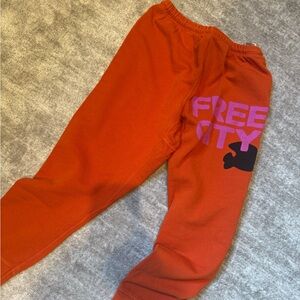 freecity  Orange Sweatpants with Pink Logo